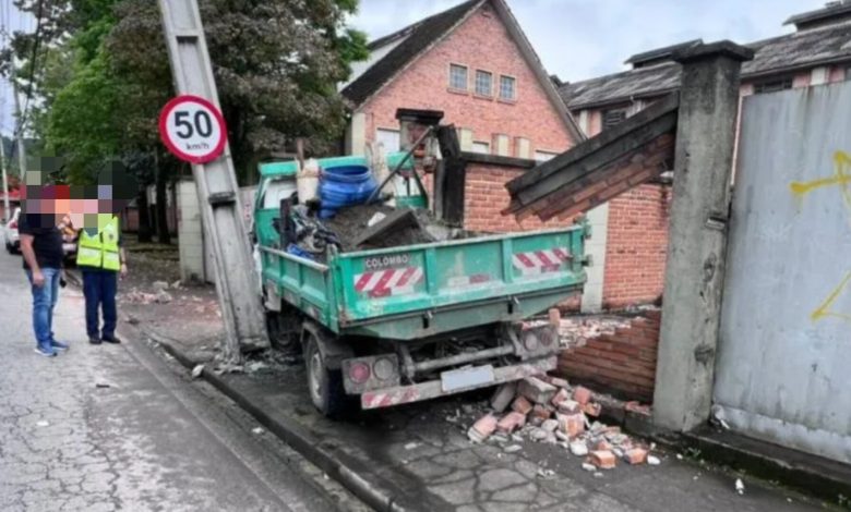 Caminhão causa danos ao atingir poste e muro, em Blumenau