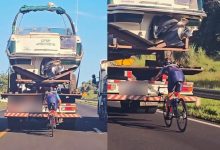 Manobra perigosa: ciclista é flagrado “colado” em caminhão com lancha em rodovia